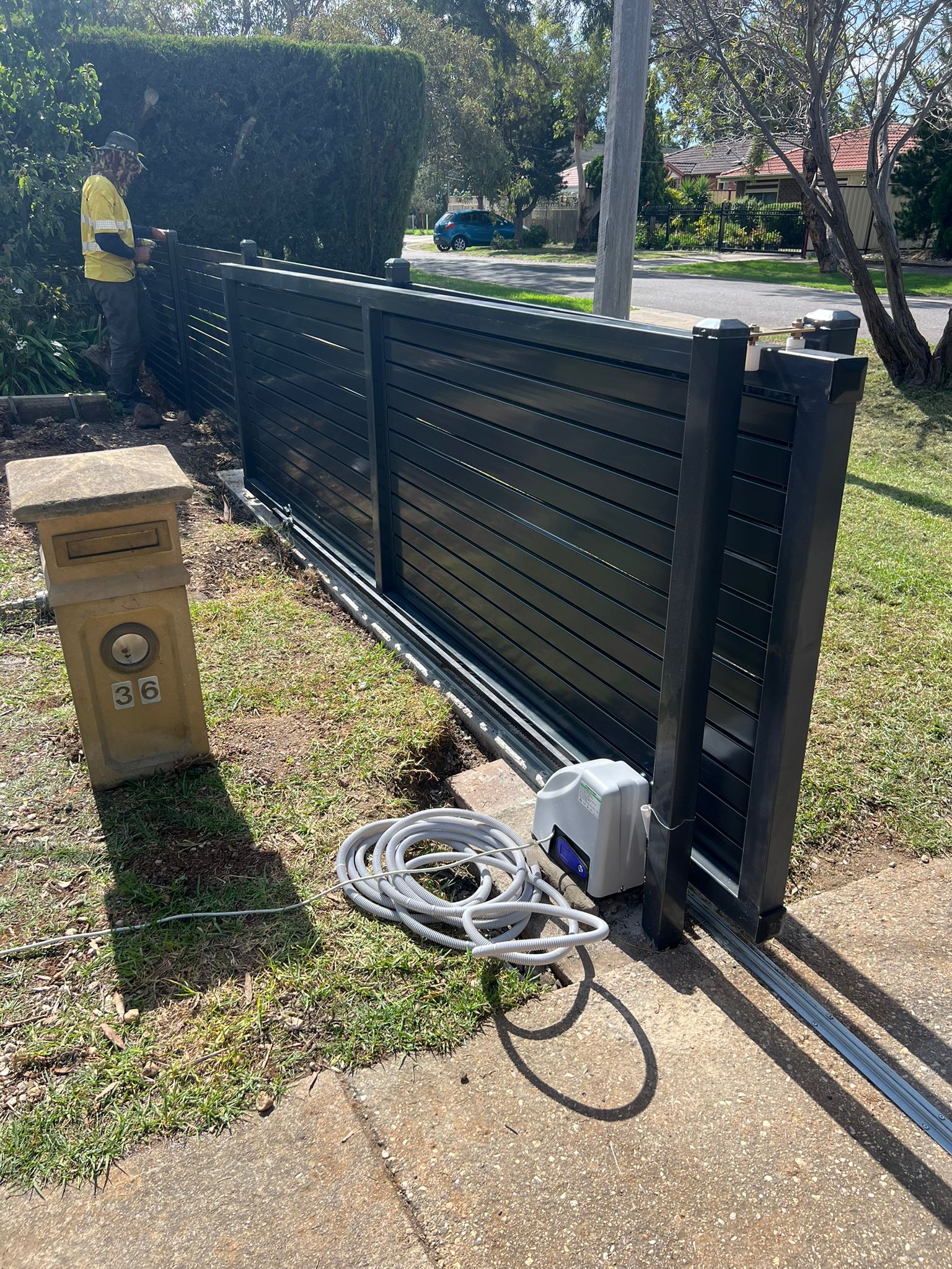 Finished automatic black aluminium slat sliding gate in Werribee