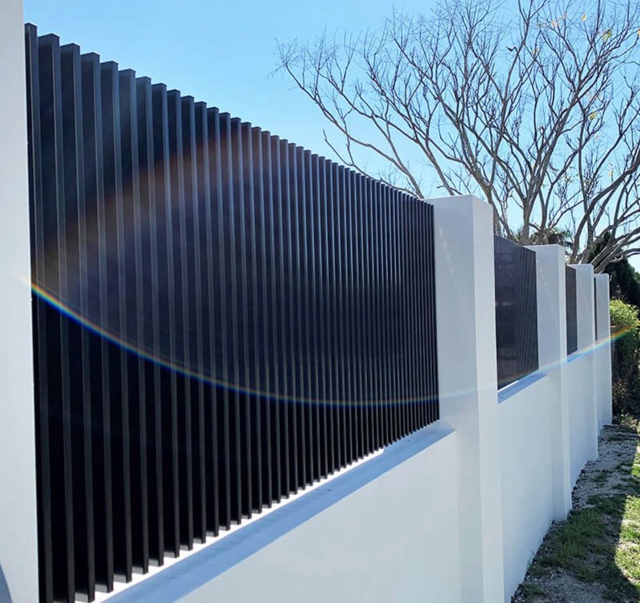 Vertical aluminium pool-style fence with rendered wall base